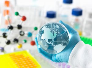 Global research, conceptual image. Scientist holding a globe with a laboratory bench and glassware in the background. image is to demonstrate a community organizer helping the community and autistic people with autism how to navigate the covid-19 corona virus