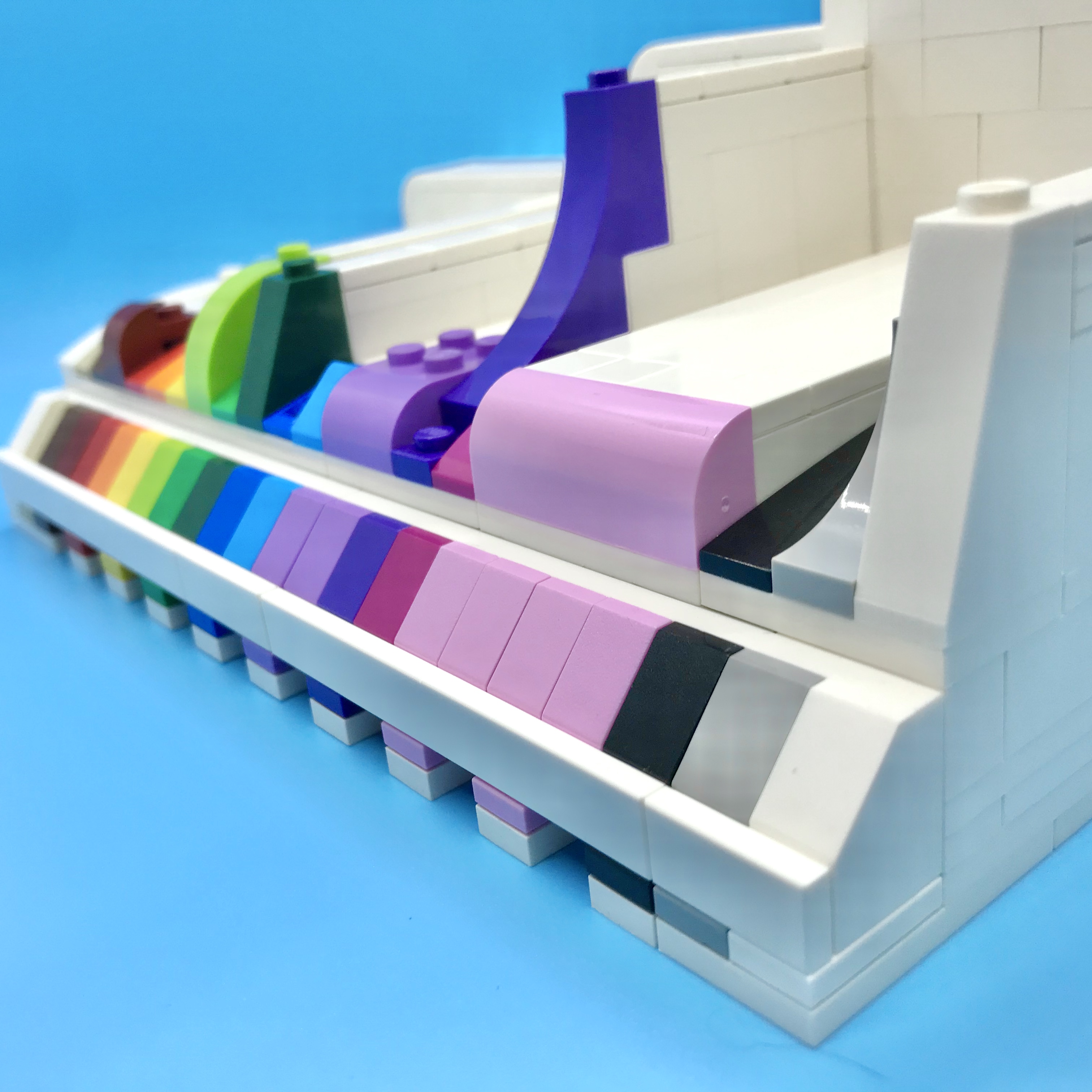 A LEGO slope display, with different slope elements and in a pleasing color order. Angled view.